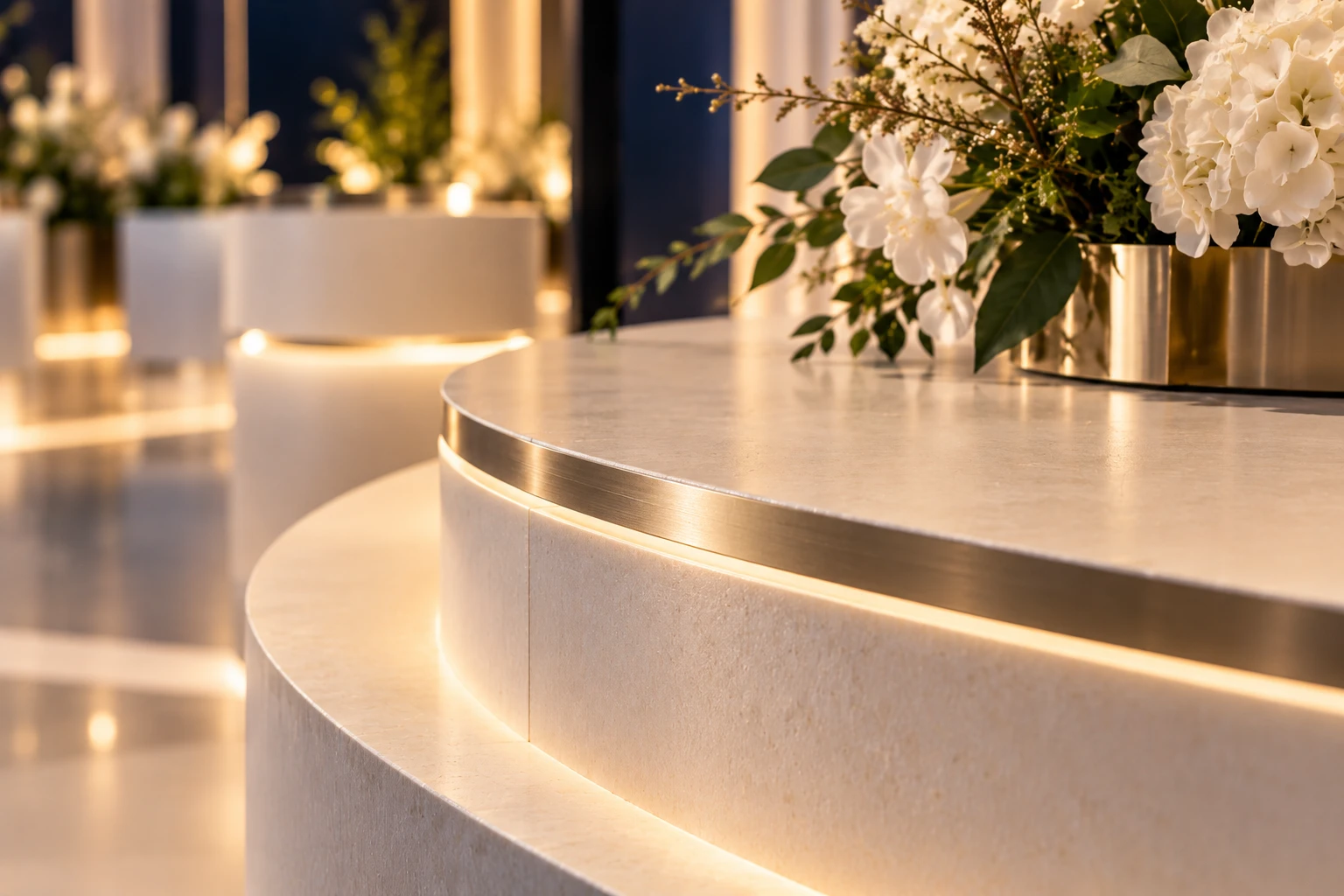 The curved edge of a display plinth with a fine metal inlay and soft underlight.