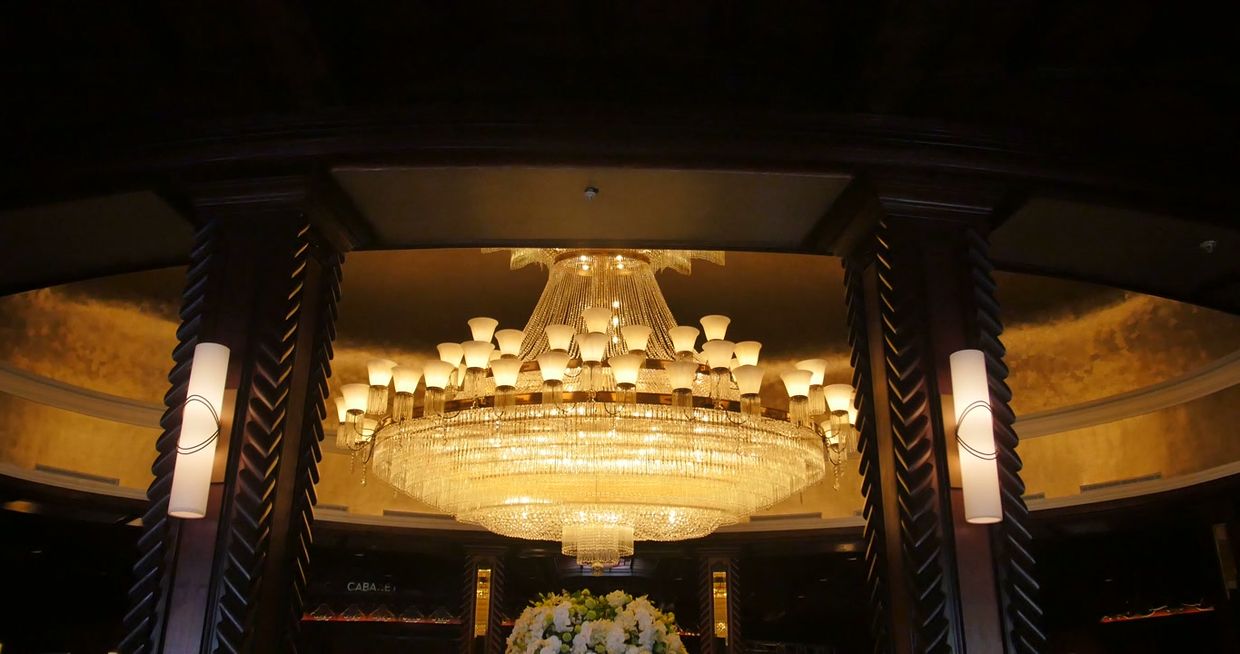 A chandelier above a hotel lobby.
