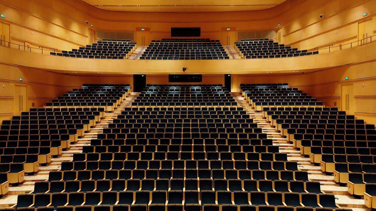 A concert hall interior revealed by a lighting cue.