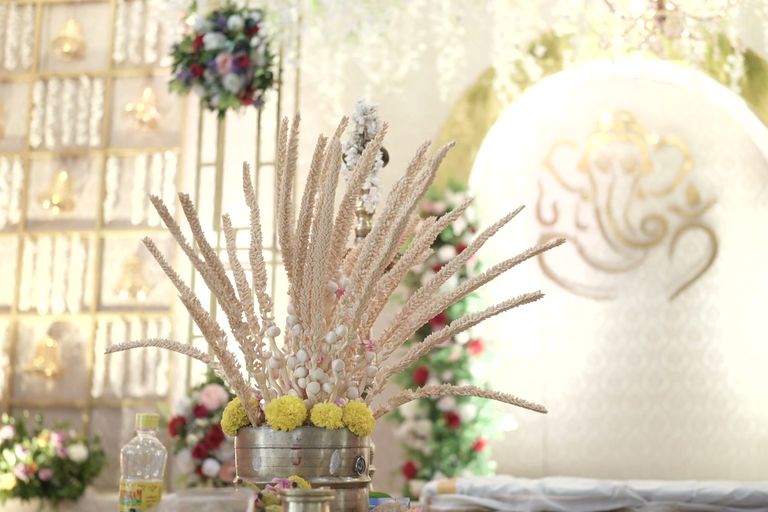 Kerala wedding décor with traditional lamps and florals.